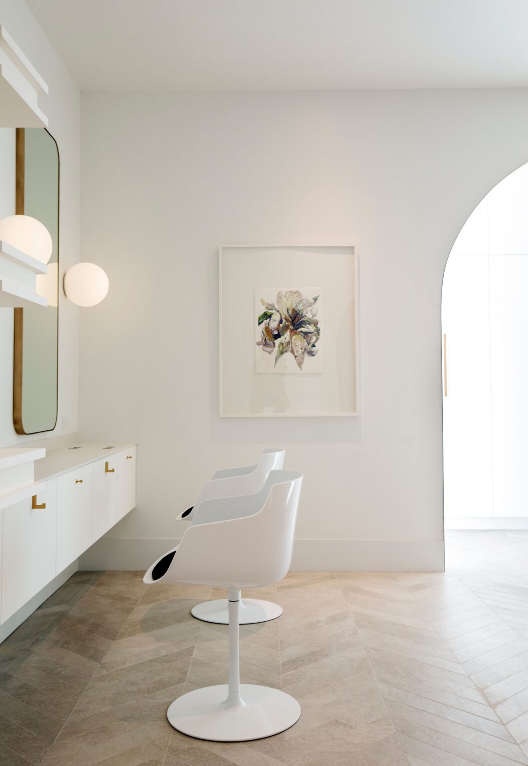 Modern styling station at Wish Dry Bar with gold-framed mirror and contemporary lighting